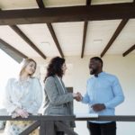 Three people at work, two of them are shaking hands. The Talent Landscape in 2025